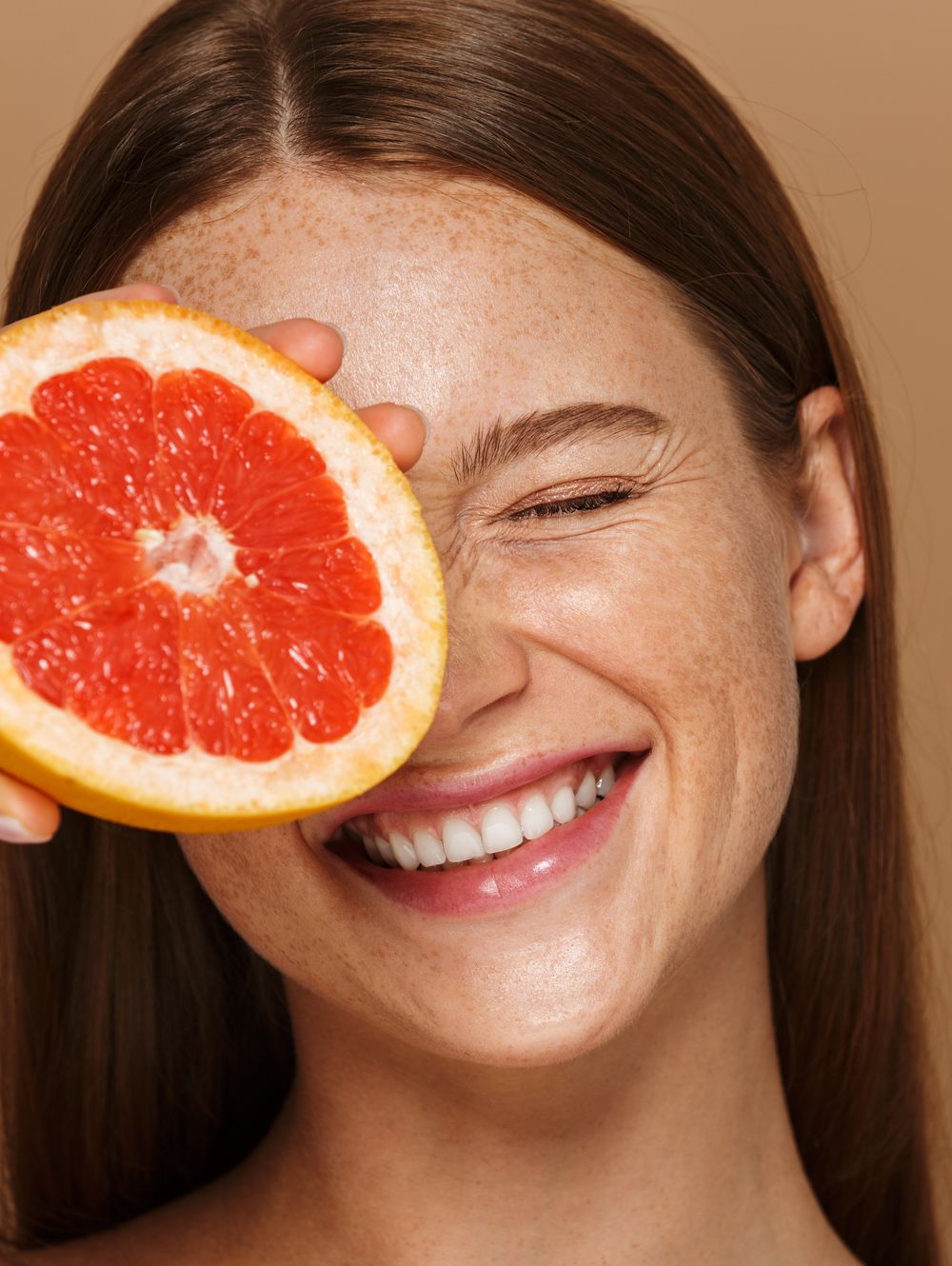 Beauty portrait of a beautiful healthy young topless womanBeauty portrait of a beautiful healthy young topless woman with long red hair showing sliced grapefruit isolated over beige backgroundhalf, beautiful, vitamin, care, woman, skin, isolated, food, face, body, grapefruit, girl, background, young, fruit, diet, closeup, cute, health, juice, juicy, beauty, perfect, smile, female, hair, portrait, healthy, minerals, happy, natural, active, purity, long, eat, funny, sensual, posing, fashion, caucasian, red, redhead, ginger
