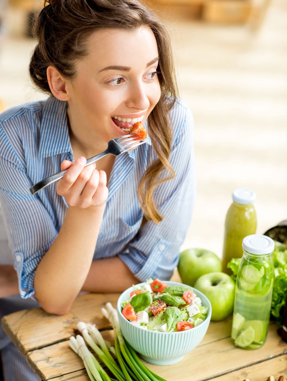 Woman eating healthy saladYoung and happy woman eating healthy salad sitting on the table with green fresh ingredients indoorssalad, green, table, fresh, mixed, vegan, food, care, healthy, raw, natural, health, freshness, diet, eat, vegetable, ingredient, vegetarian, nuts, cherry, onion, bottle, woman, eating, detox, kitchen, happy, lifestyle, nutrition, meal, girl, organic, summer, dieting, female, smiling, vegetables, smoothie, beautiful, home, greenery, young, smile, people, sitting, t-shirt