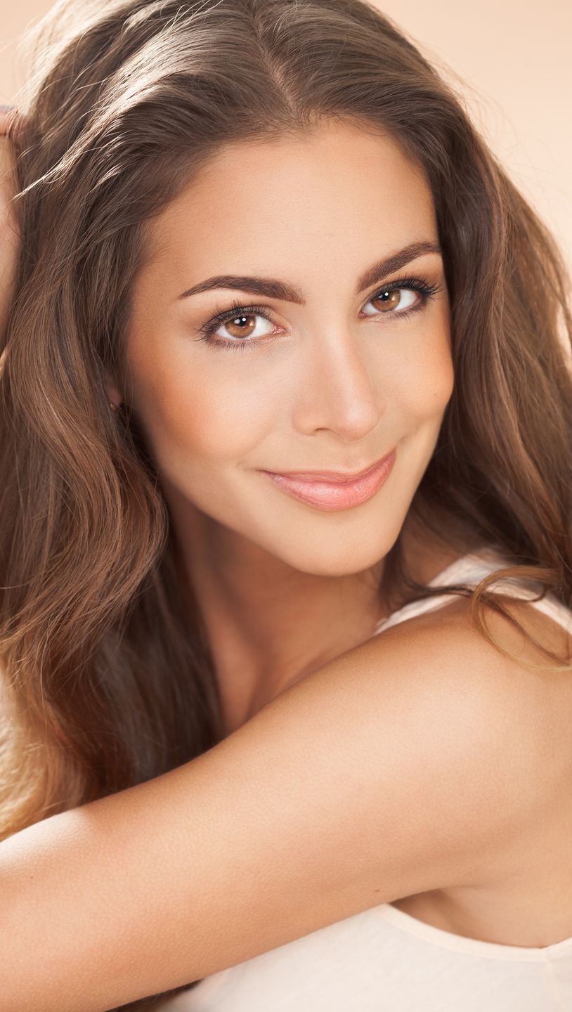Fashion and beauty concept in studio.Katja de Bruijnwoman, beauty, studio, portrait, beautiful, European, adult, Caucasian, makeup, face, elegant, posing, fashion, fashionable, style, long hair, portrait, closeup, young woman, brown, eyes, hairstyle, modern, fresh, twenty, vertical, smile, hands, sitting, resting, shiny, beige, warm, tanned