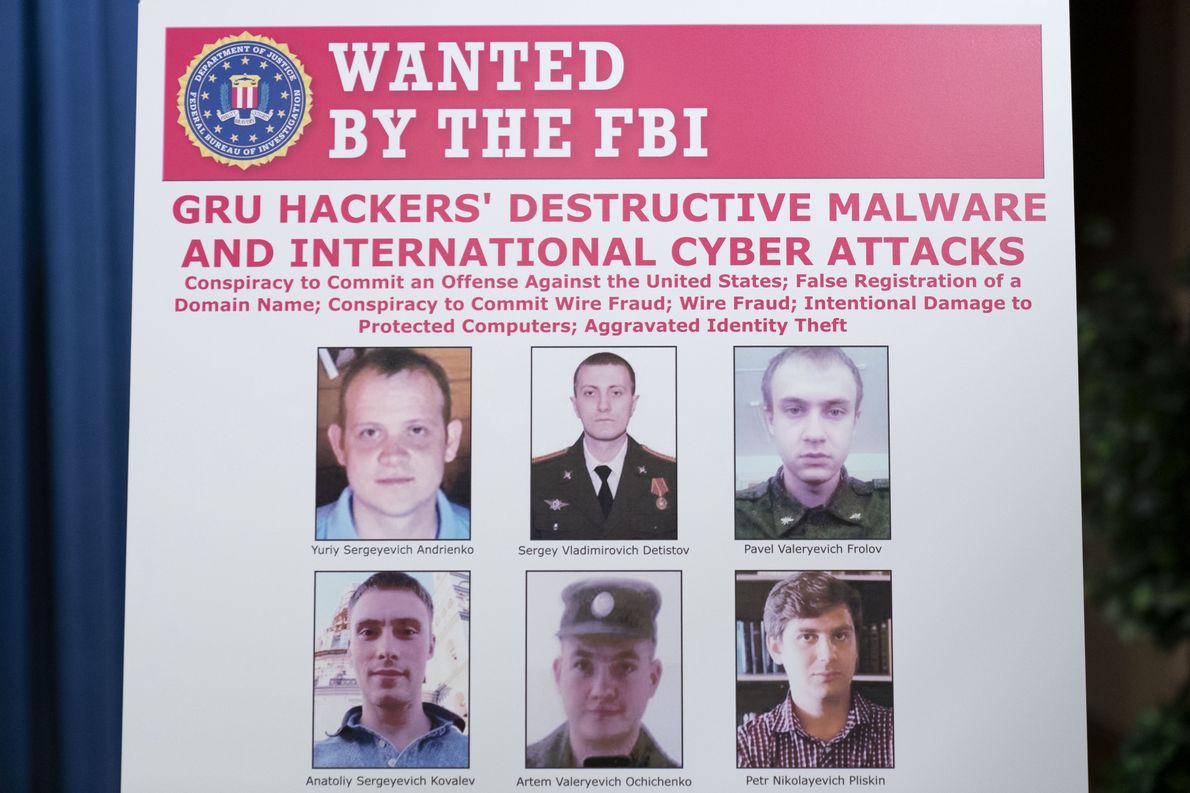 WASHINGTON, DC - OCTOBER 19: A poster showing six wanted Russian military intelligence officers is displayed before a news conference at the Department of Justice, on October 19, 2020 in Washington, DC. The Justice Department announced an indictment against six Russia GRU officers charged with engaging in a series of hacking and malware deployment operations to attack other countries\' infrastructure, elections and other actions designed to further Russia\'s interests. (Photo by Andrew Harnik - Pool/Getty Images)