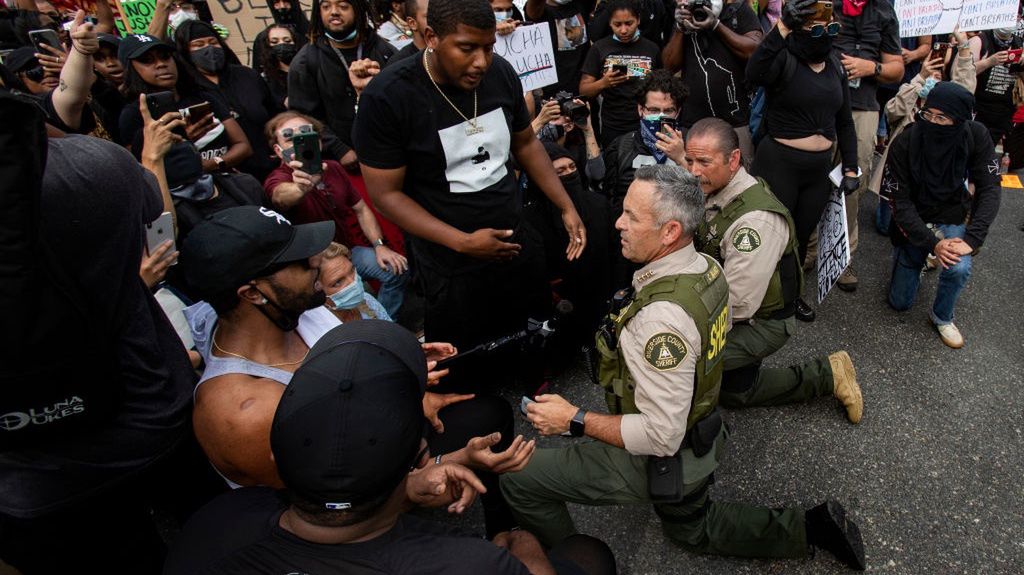Riverside, Kalifornia. Policjanci przyklękają na jedno kolano w geście solidarności z protestującymi
