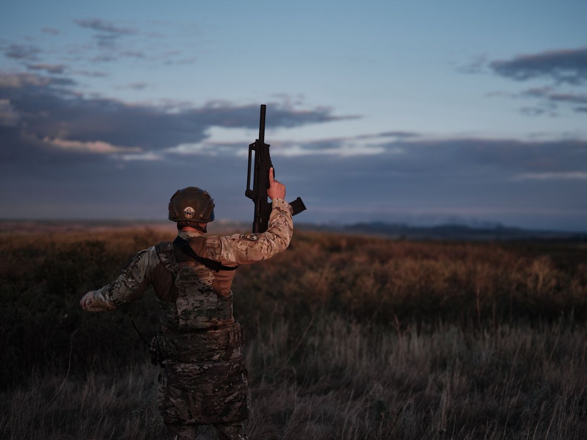 TORETSK DISTRICT, UKRAINE - JULY 31: A soldier with a machine gun in his hands looks at the sky and detects enemy drones on July 31, 2024 in Toretsk district, Ukraine. The Russians are attacking Toretsk daily with artillery, guided air bombs, and FPV drones that fly in the city and hunt for cars. (Photo by Kostiantyn Liberov/Libkos/Getty Images)