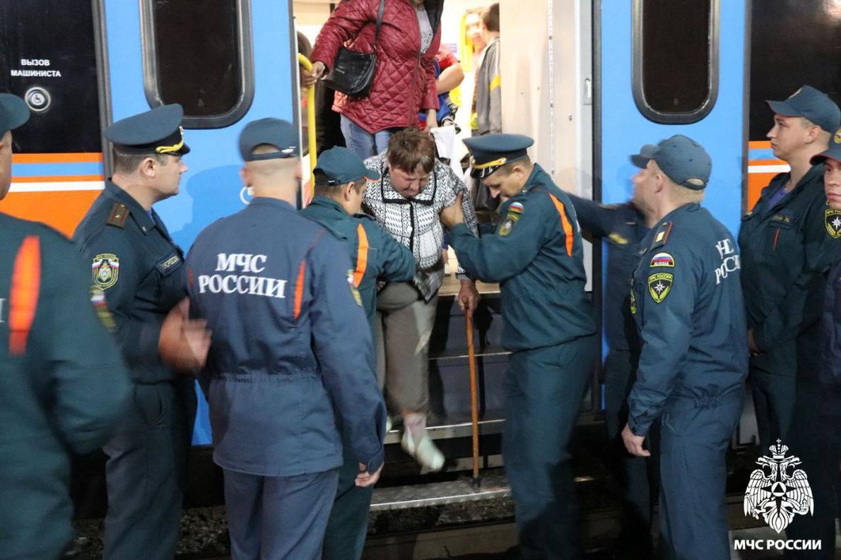 ORYOL, RUSSIA - AUGUST 9: (----EDITORIAL USE ONLY - MANDATORY CREDIT - \'RUSSIAN MINISTRY OF EMERGENCY SITUATIONS / HANDOUT\' - NO MARKETING NO ADVERTISING CAMPAIGNS - DISTRIBUTED AS A SERVICE TO CLIENTS----) Employees of the Russian EMERCOM help the people, who are forced to leave the border settlements, as they have arrived from the Kursk region at a railway station in Oryol, Russia on August 9, 2024. Authorities organized temporary accommodation, food, medical and informational support for more than 80 people, which 24 of them are children. Ukrainian army launched a full-scale attack on Russia\'s southern Kursk region, creating a new front in the conflict. (Photo by Russian Emergencies Ministry/Anadolu via Getty Images)