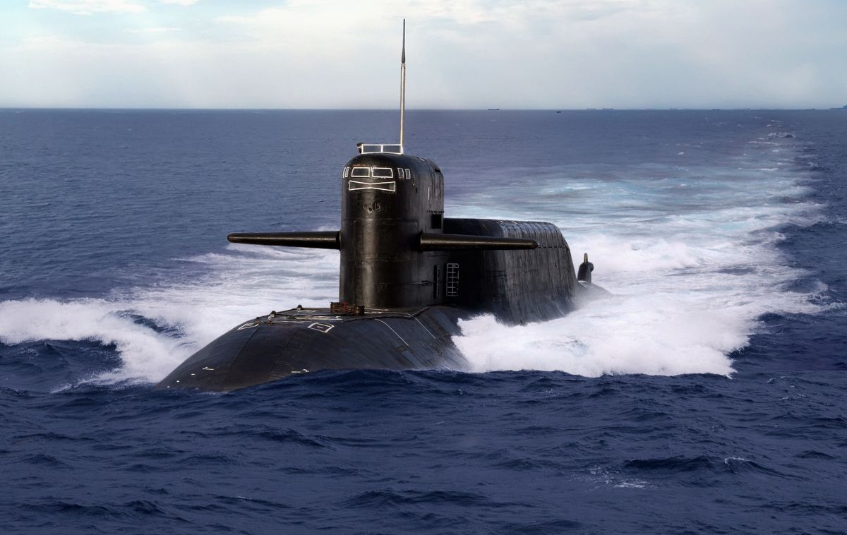 Three British submarines at sea, one carrying nuclear arms
