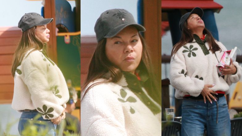 Naturalna Edyta Górniak w beżowym "baranku" przechadza się po Sopocie i spogląda w niebo