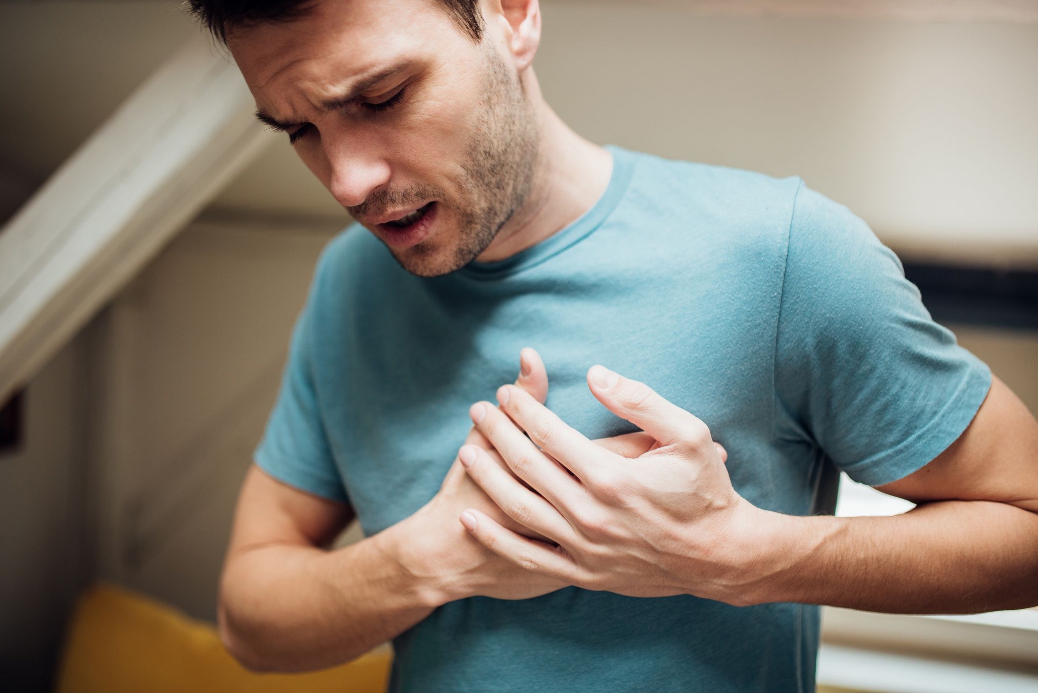 Ill man holding his chest
Young man having strange chest pain
RgStudio