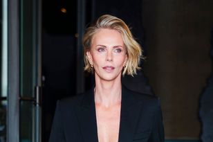 Charlize Theron stuns in black-and-white velvet at Odyssey London premiere