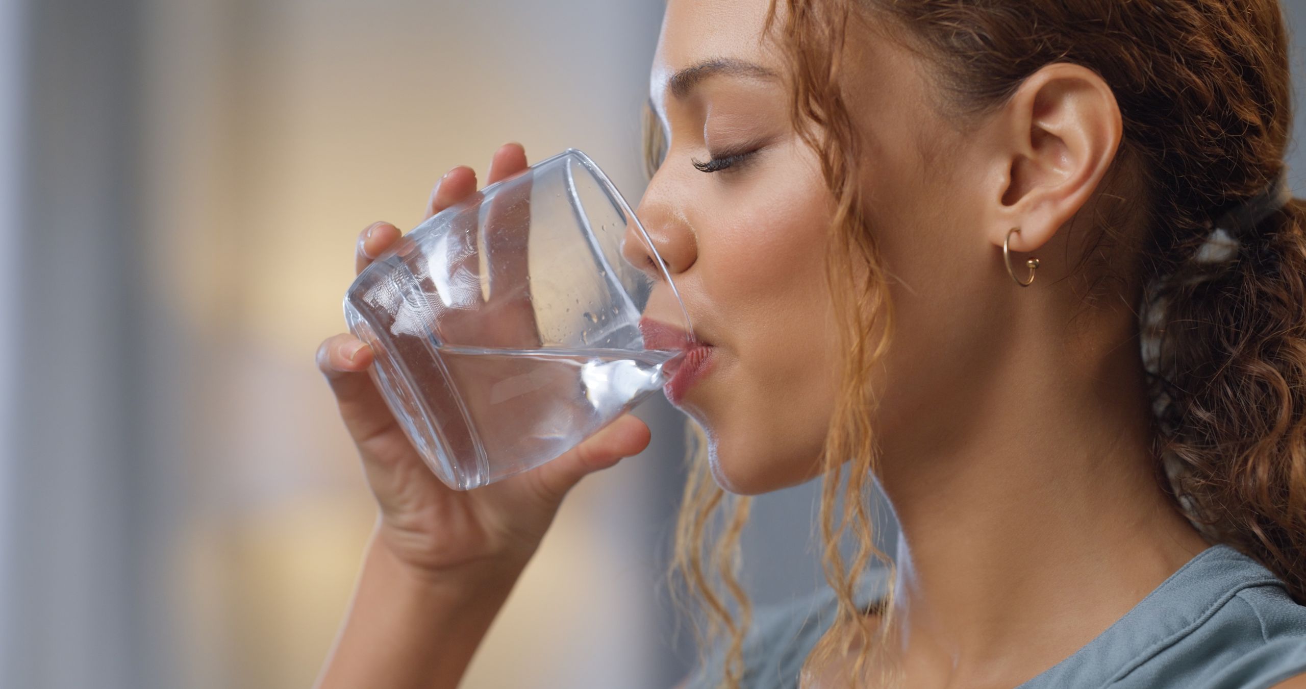 Closeup of a woman drinking a glass of water for hydration, thirst and health at her house. Happy girl with a wellness, diet and healthy lifestyle enjoying a fresh aqua drink while relaxing at home.
Closeup of a woman drinking a glass of water for hydration, thirst and health at her house. Happy girl with a wellness, diet and healthy lifestyle enjoying a fresh aqua drink while relaxing at home.
Sean Anthony Eddy