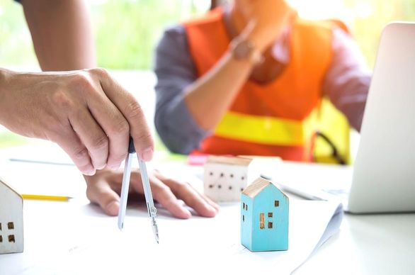 dwie osoby pracują nad projektem budowlanym