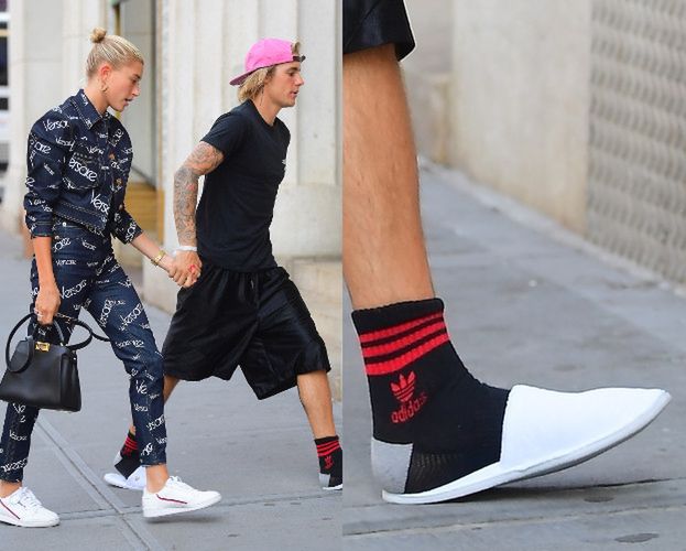   Bieber in slippers leads a shopping girl 