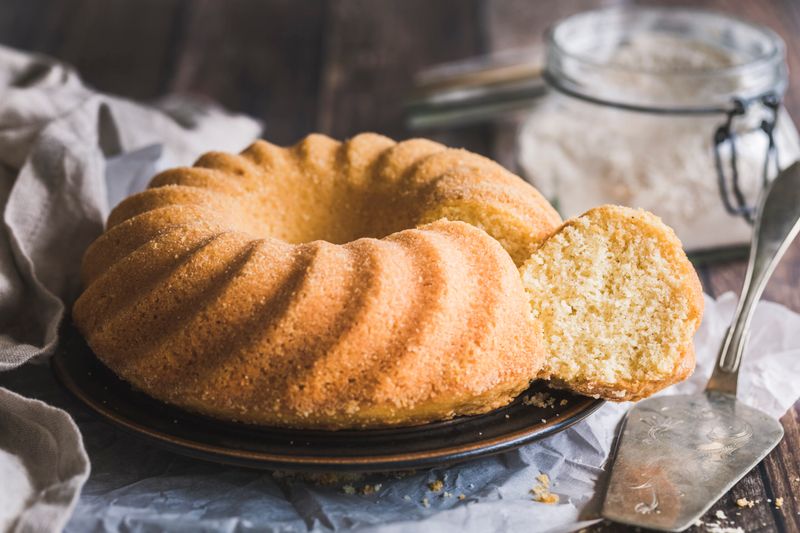 Sponge cake, Kugelhopf cake, or traditional swedish sockerkaka on a wooden background.
