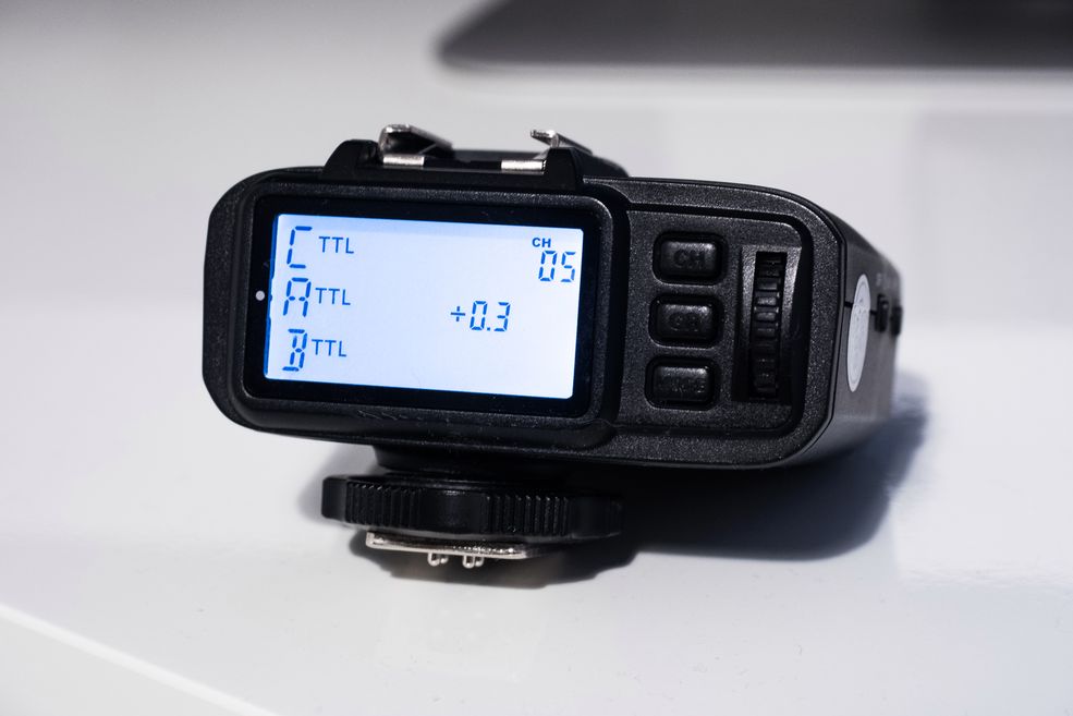 Do wyzwalania lampy wykorzystałem nadajnik Quadralite Navigator X, który oferuje współpracę z systemami TTL i HSS. Dodatkowo, wyposażony jest w stopkę lampy błyskowej, więc nie przeszkadza w umieszczeniu lampy systemowej na sankach, jak również wyposażony jest w hologram wspomagający działanie autofokusu.