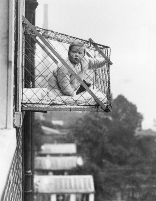27th January 1934: An example of the wire cage which East Poplar borough council in London propose to fix to the outside of their tenement windows, so that babies can benefit from fresh air and sunshine. (Photo by Fox Photos/Getty Images)