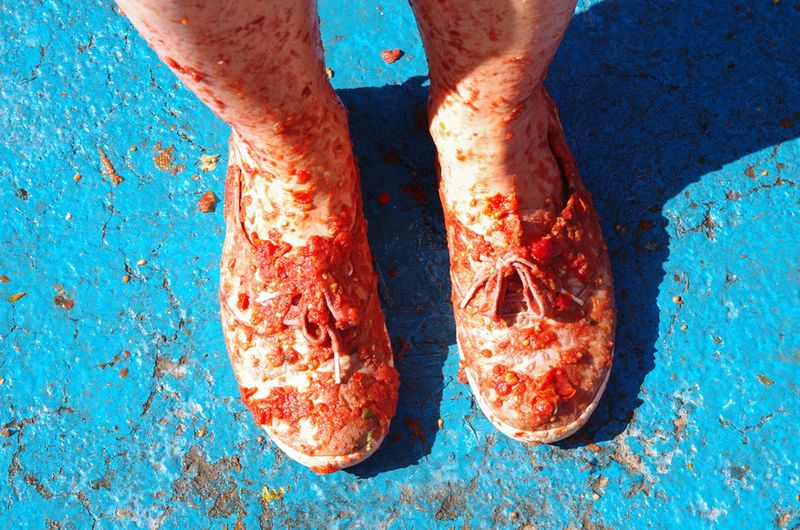 Ubrudzone buty pomidorami podczas święta La Tomatina w Bunol