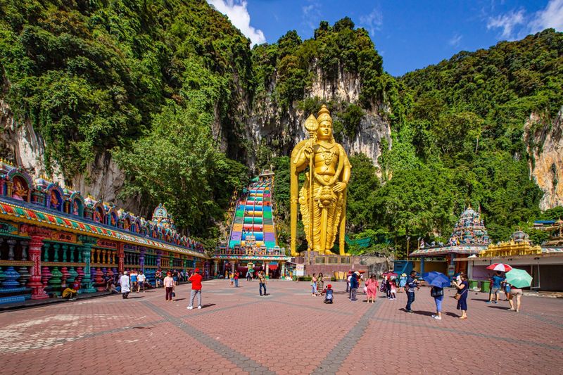 Batu Caves ze złotym posągiem i kolorowymi schodami