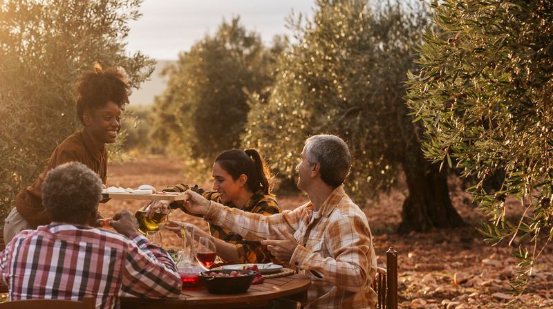 Grupa osób jedzących posiłek w plenerze