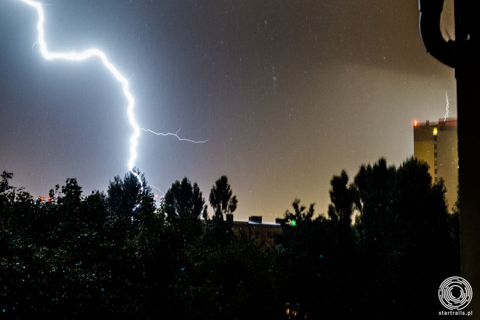 Poznańskie Rataje widok na północny zachód widok z balkonu na 4 piętrze. Piorun uderzył w bliskiej odległości od miejsca wykonywanie fotografii co spowodowało poruszenie aparatu. Drzewa i wysokość bardzo ograniczały widok. 20130804-003 Canon 1D Mark IV, Canon 24-70 mm f/2.8, ISO 400, F/6.3 T 6 s.