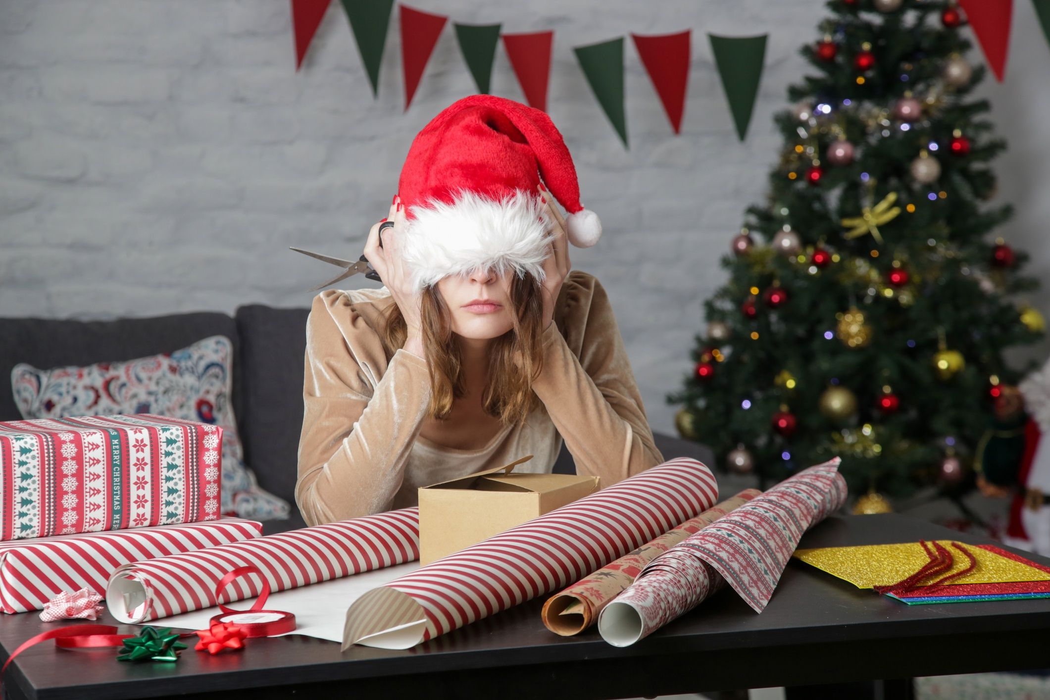 Depressed frustrated woman wrapping Christmas gift boxes, winter holiday stress conceptDepressed frustrated woman wrapping Christmas gift boxes, winter holiday stress concepttrioceanribbon, merry, alone