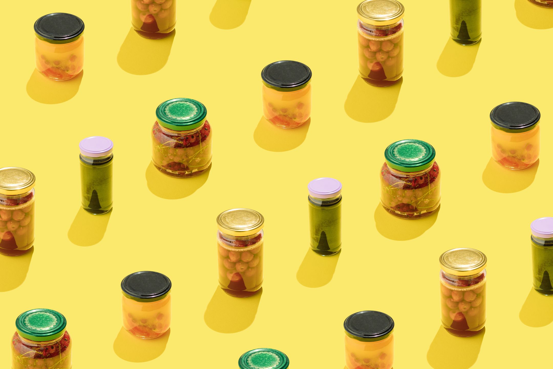 Winter stores pattern. Pickled fruit and vegetables in jars on yellow background.aesthetics, amazing, art, autumn, background, canning, concept, container, cooking, design, diet, eating, fermentation, food, foodie, fruit, glass, green, healthy, high angle view, homemade, ingredient, jam, jar, kitchen, marinated, natural, nutrition, organic, organic food, pickled, product, still life food, storage, store shelves, style, vegetable, vegetarian, veggy, vinegar, vivid, winter, yellow, yellow background
